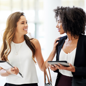 Two coworkers talking to each other in a healthy manner.